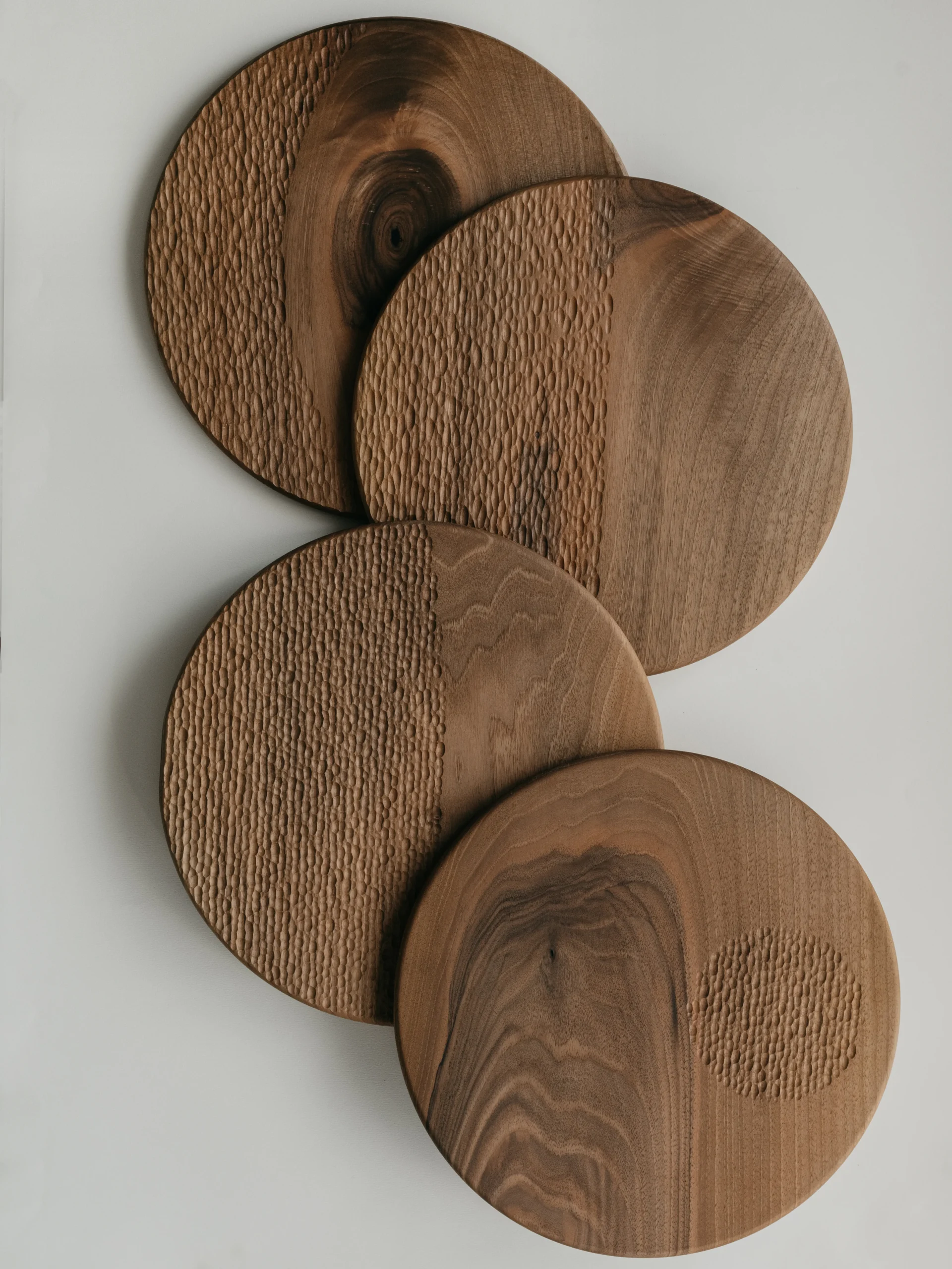 The Moon is a collection of four wooden serving boards made of selected walnut wood. Each plate has a different pattern presenting the phases of the moon.